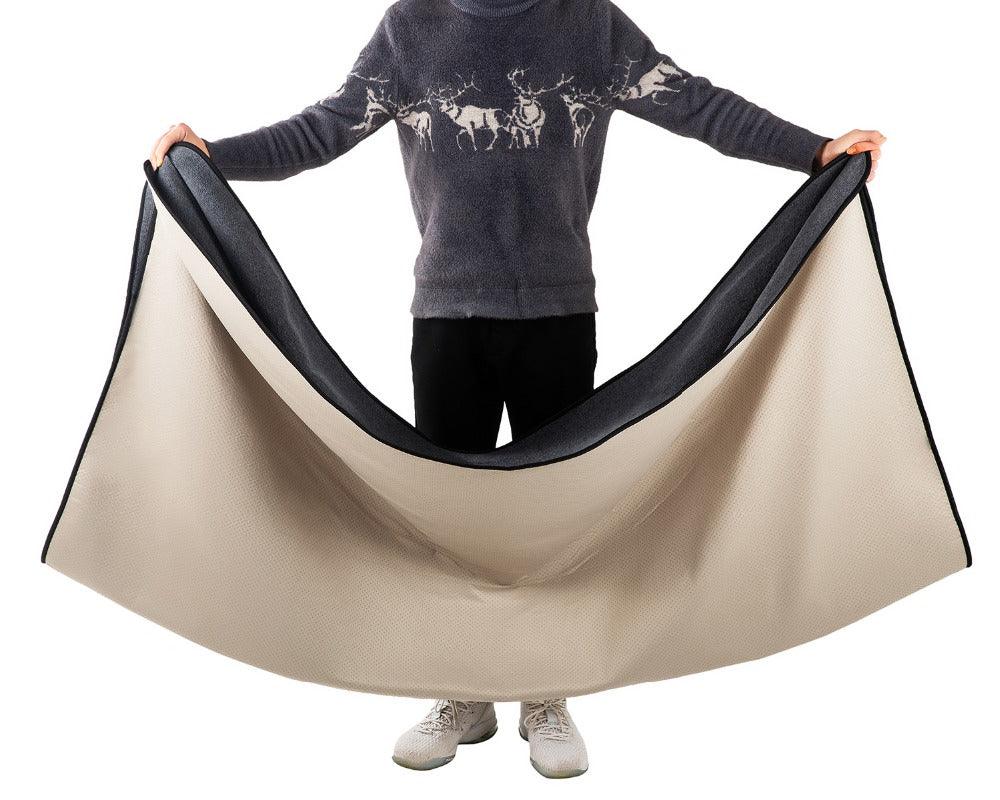 Man holding open a Dog Blanket and waterproof pad