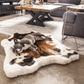 Dog lying on a cowhide rug in a modern living room.