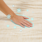 Hand on a textured surface with snowflake graphics
