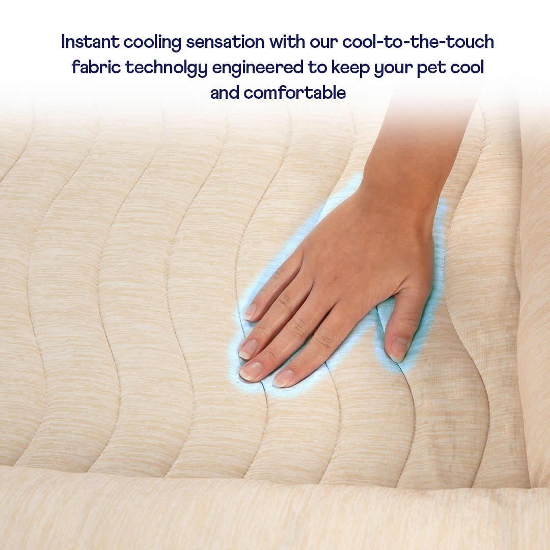 Hand touching a cooling pad with text about cool-to-the-touch fabric technology.