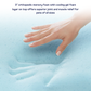 Hand pressing into a blue orthopedic memory foam pad with text about its benefits.