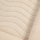 Close-up of a beige fabric with wavy texture