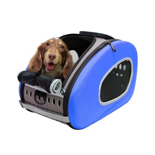 Dog inside a blue pet carrier on a white background