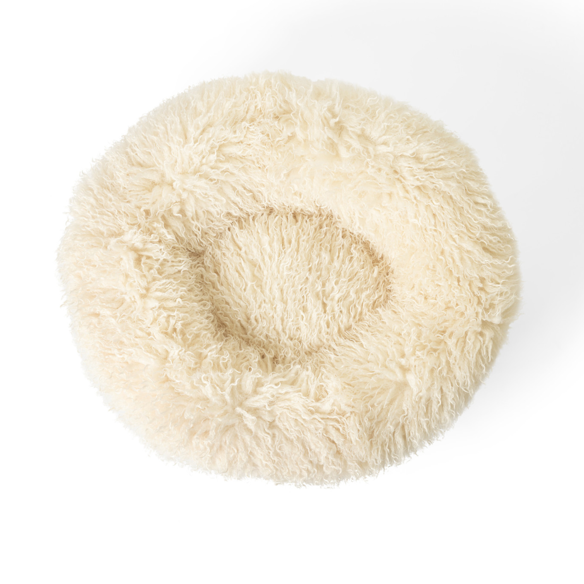 Round, fluffy white pet bed on a white background