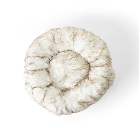 Round fur pet bed on a white background