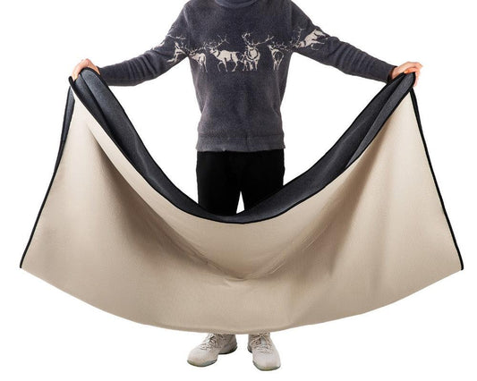 Man holding open a Dog Blanket and waterproof pad