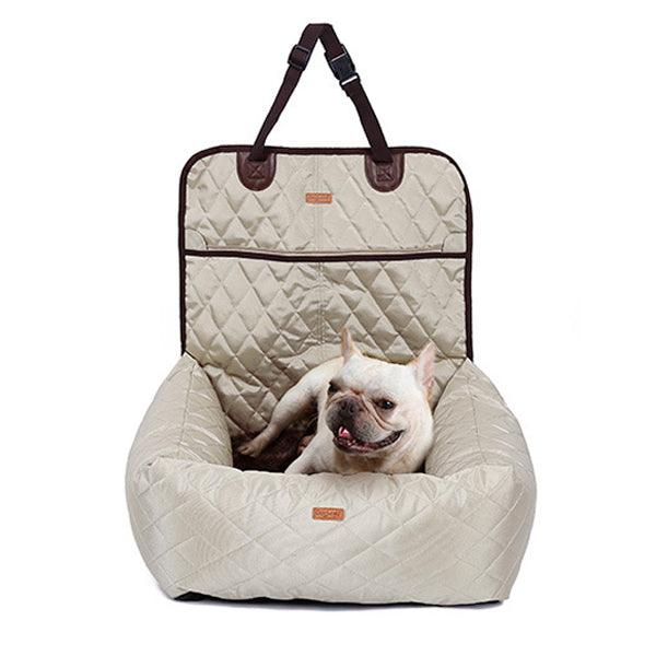 French Bulldog sitting in a dog car seat bed in beige