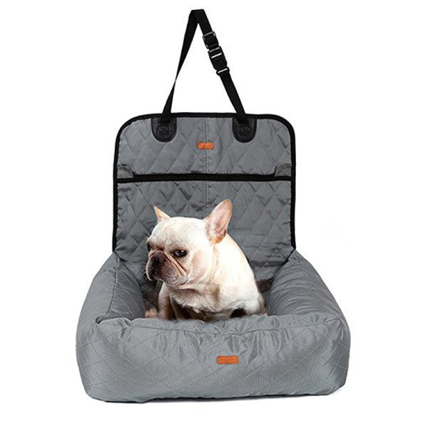 French Bulldog sitting in a dog car seat bed in gray