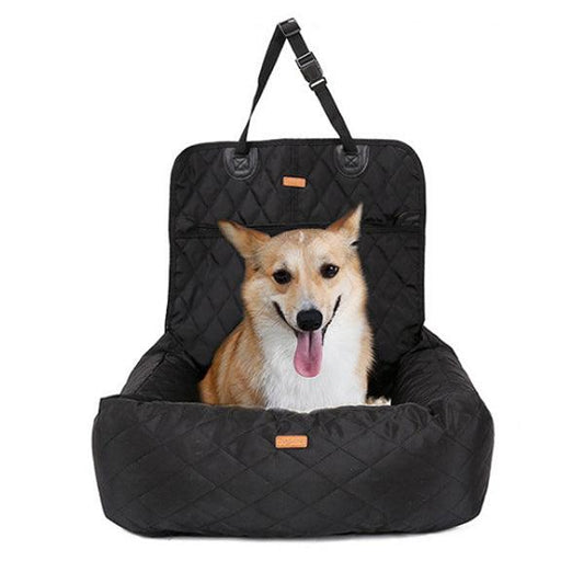 Corgi sitting in a dog car seat bed in black