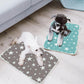Mini Schnauzer dogs sitting on two small washable dog pee pads